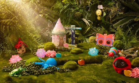 Image of fairy themed toys from brand Discovery Zone sitting in enchanted moss garden